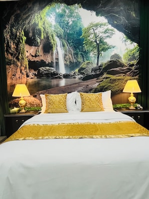 A bed with a view of a waterfall and forest through an archway. - Modern Delta Stay Near Vancouver + Parking (Delta)
