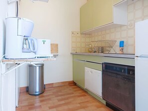 A compact kitchen with a coffee maker, a trash bin, a dishwasher, and a microwave. - Les Jardins du Soleil by Interhome (Six Fours)