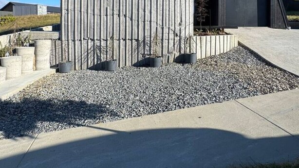 A modern house with a sloped roof, a large window, and a concrete driveway. - Blue Moon Apartment-Epic Mountain views Wanaka. (Wānaka)