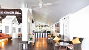 A spacious lobby with a bar area, seating arrangements, and a ceiling fan. - Koh Hai Fantasy Resort and Spa (Ko Lanta)