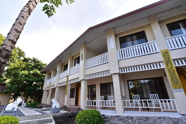 A multi-story hotel with balconies, a stone facade, and a number 2215 sign. - Koh Hai Fantasy Resort and Spa (Ko Lanta)