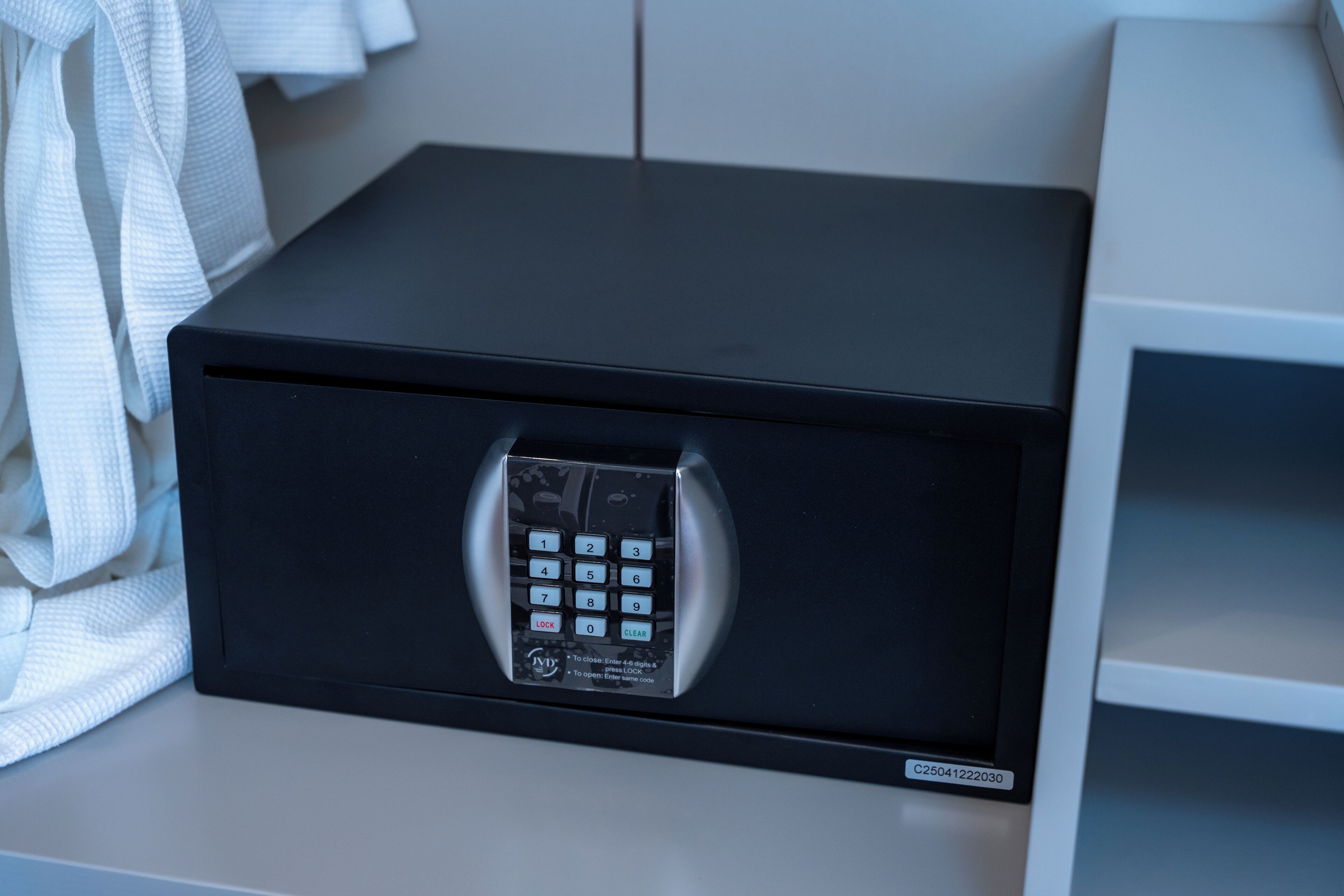 A black safe with a numeric keypad and a clear lock button.