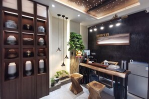 A modern kitchen with wooden cabinets, pendant lighting, and a black backsplash. - Phoenix Suiyu Riverview Homestay (North Gate Chenglou Branch) (Fenghuang)