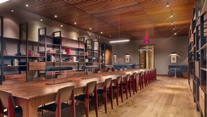 A modern library with a long wooden table and chairs, bookshelves, and a ceiling with wooden slats. - Blueground | Chelsea, rooftop, nr The Vessel (New York)