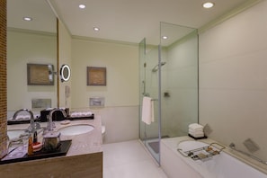 A modern bathroom with a glass-enclosed shower, a double sink vanity, and a large bathtub. - ITC Maurya, a Luxury Collection Hotel (New Delhi)
