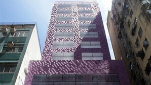 A tall building with a purple facade and multiple windows. - V Wanchai Serviced Apartments (Hong Kong Island)