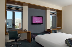 A hotel room with a bed, desk, chair, television, and large windows. - Aloft Haidian Hotel Beijing (Beijing)