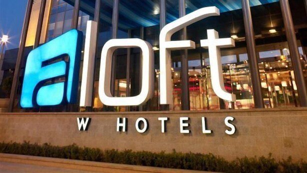 A modern hotel with a prominent 'aLoft' sign, large glass windows, and a structured facade. - Aloft Haidian Hotel Beijing (Beijing)