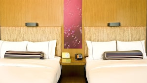 A hotel room with two beds, a nightstand with a clock and phone, and a wall with a bubble pattern. - Aloft Haidian Hotel Beijing (Beijing)