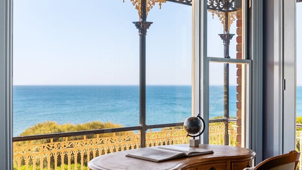 A room with a view of the sea, a wooden desk, and a globe. - Pelican Clifftop Estate | Magistic views with pool (Mount Eliza)