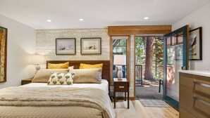 A bedroom with a bed, a nightstand, a desk, and a view of the outdoors. - Newly Listed! Designer Mountain Retreat Steps from the Gondola. Great Winter Availability! (Aspen)