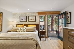 A bedroom with a bed, a nightstand, a desk, and a view of the outdoors. - Newly Listed! Designer Mountain Retreat Steps from the Gondola. Great Winter Availability! (Aspen)