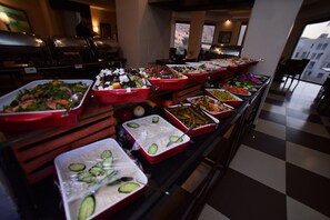 A buffet with various food options, including salads, fruits, and vegetables. - La Maison Hotel (Wadi Musa)