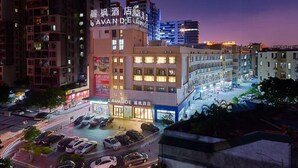 A hotel with a prominent sign, multiple floors, and a parking area. - Lavande International Hotel Pazhou Convention & Exhibition Center Eastxiaonan Metro Station Branch - Free Deliver Service to Guangzhou Baiyun International Airport & Free Shuttle Bus to Canton Fair Complex During Canton Fair Period (Guangzhou)