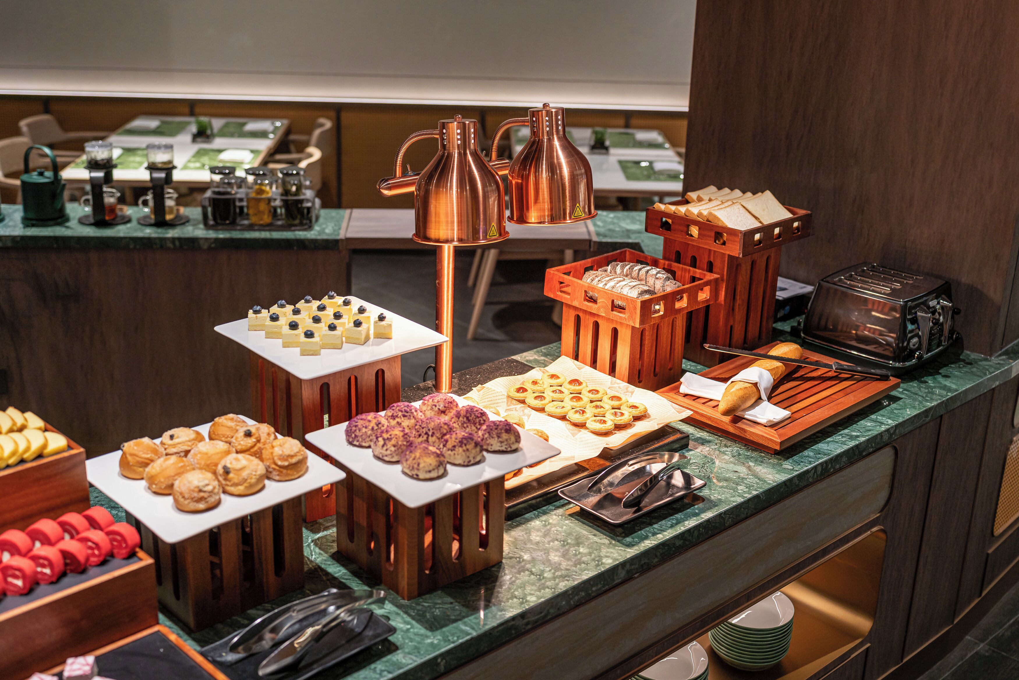 A buffet with various food items and a coffee station.
