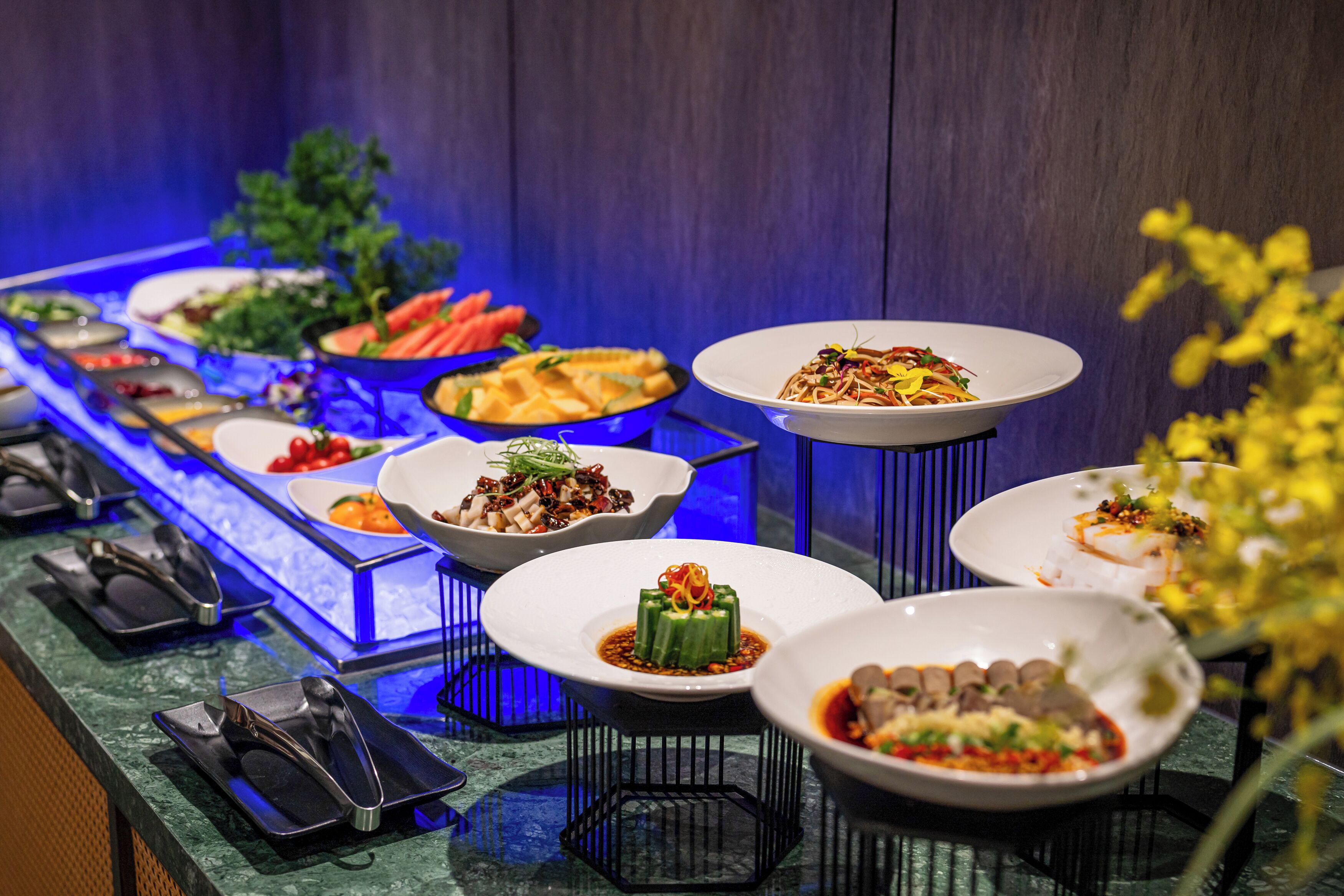 A buffet with various dishes and utensils.