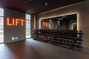 A gym with weight racks and neon 'LIFT' signs. - Student Only True Liverpool (Liverpool)