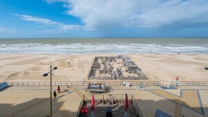Ein Hotel direkt am Strand mit einem großzügigen Außenbereich, Parkplätzen und Blick auf den Ozean.
