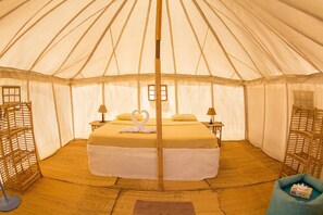 A tent with a bed, two lamps, and a wooden ladder. - Marsa Shagra Village (Marsa Alam)