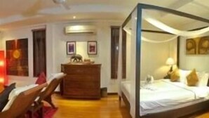 A room with a bed, a wooden dresser, and a chair. - Villa Por de Sol (Koh Samui)