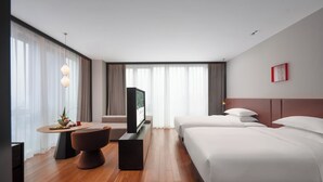 A hotel room with a wooden floor, a desk with a chair, two beds, a TV, and a large window with curtains. - SSAW Garden Hotel Chengdu - Chunxi Road Taikoo Li Branch (Chengdu)