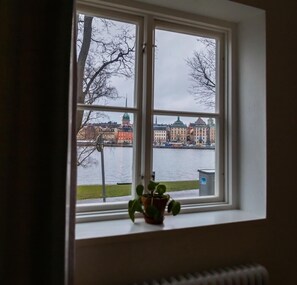 A window with a view of a cityscape and a body of water. - Stf Af Chapman Hostel (Stockholm)