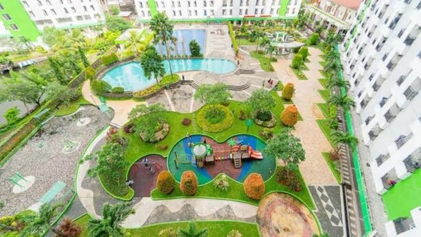 A residential complex with a central swimming pool, landscaped gardens, and a children's play area. - Japlen Room (South Tangerang)