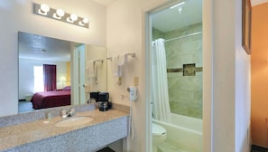 A bathroom with a sink, mirror, and shower. - M-star Bradenton (Bradenton)