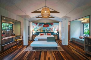 A modern bedroom with a large bed, a mural, and a wooden floor. - Nayara Gardens (San José)