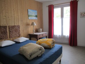 A room with a bed, a desk, a lamp, and a window with curtains. - La Source - Appartment & terrace - 90m2 - France, Auvergne Volcanoes Park (Orcival)
