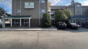 A two-story building with a sign reading "HomeTowne Studios." - Sun Suites of Louisville (Louisville)
