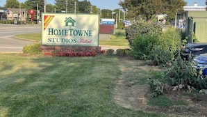 A sign for Hometown Studios by Red Roof, indicating a home improvement store. - Sun Suites of Louisville (Louisville)