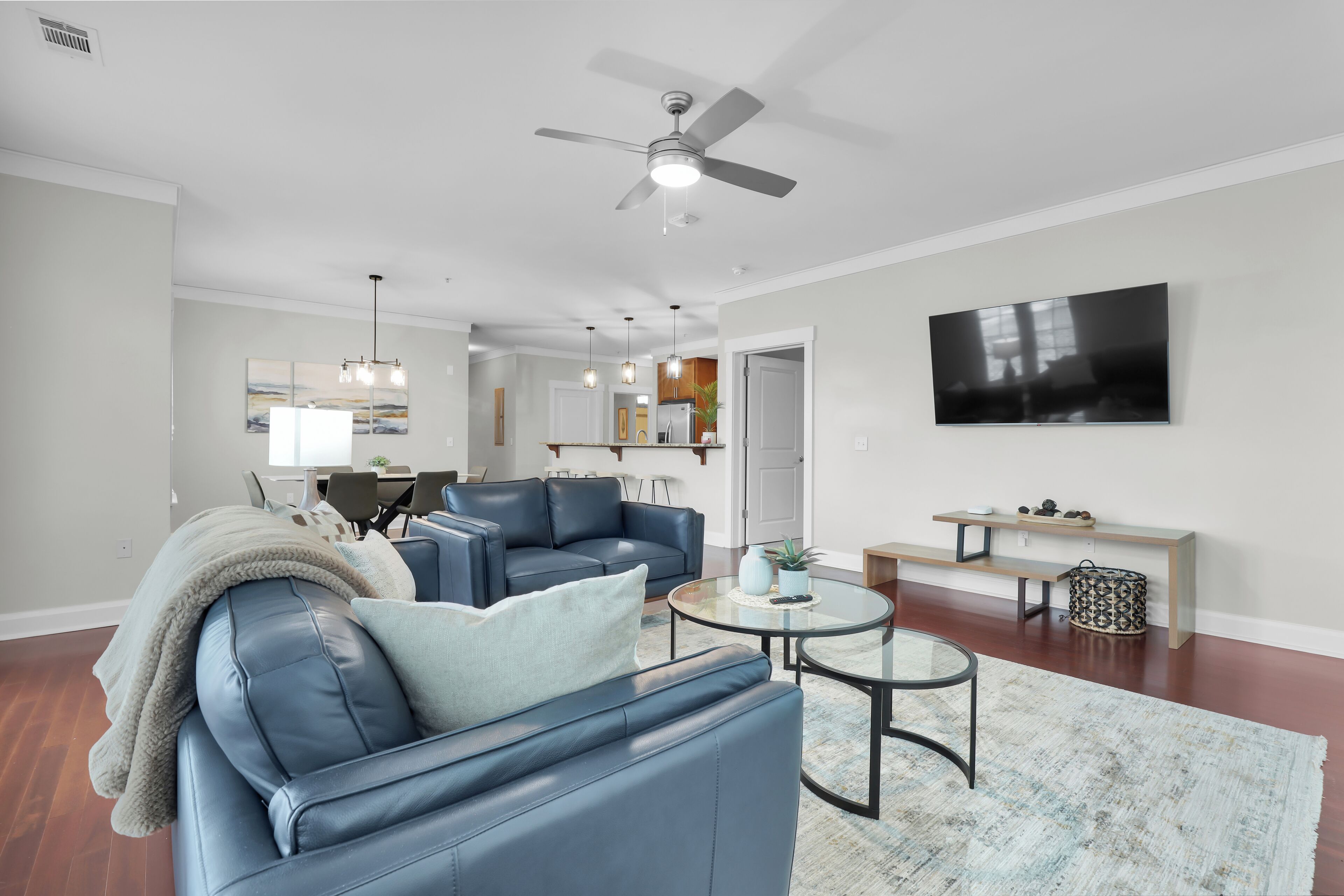 A sunlit, modern living room offering both comfort and style for relaxing moments.