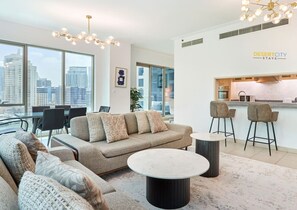 Una sala de estar moderna con sofá, mesa de centro y taburetes de bar.