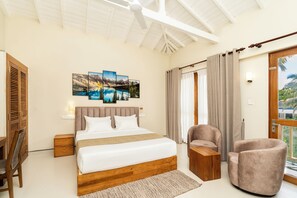A bedroom with a large bed, a wooden nightstand, a chair, and a painting on the wall.