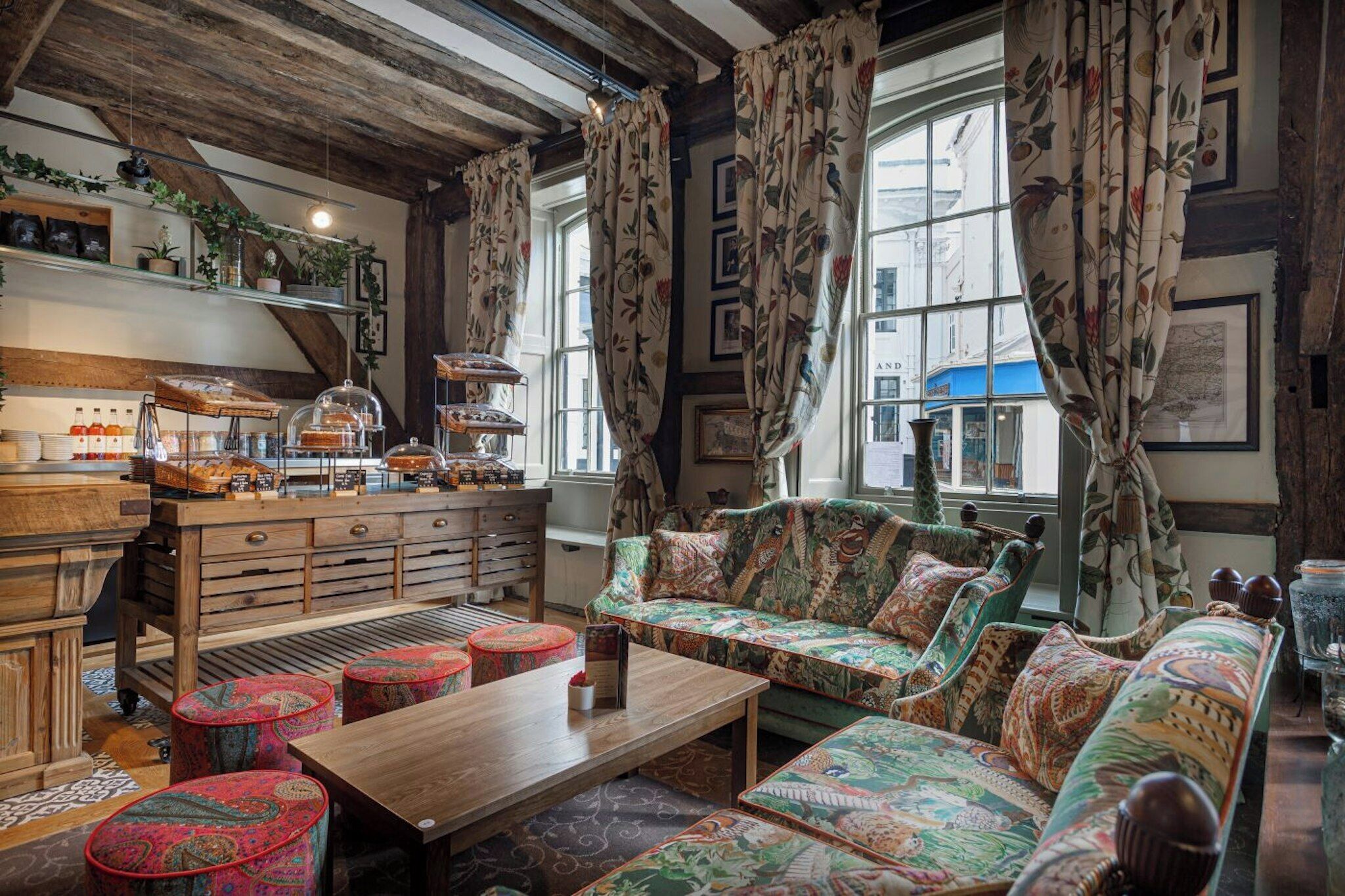 A cozy room with a wooden bench, a sofa, and a table with a glass display case.