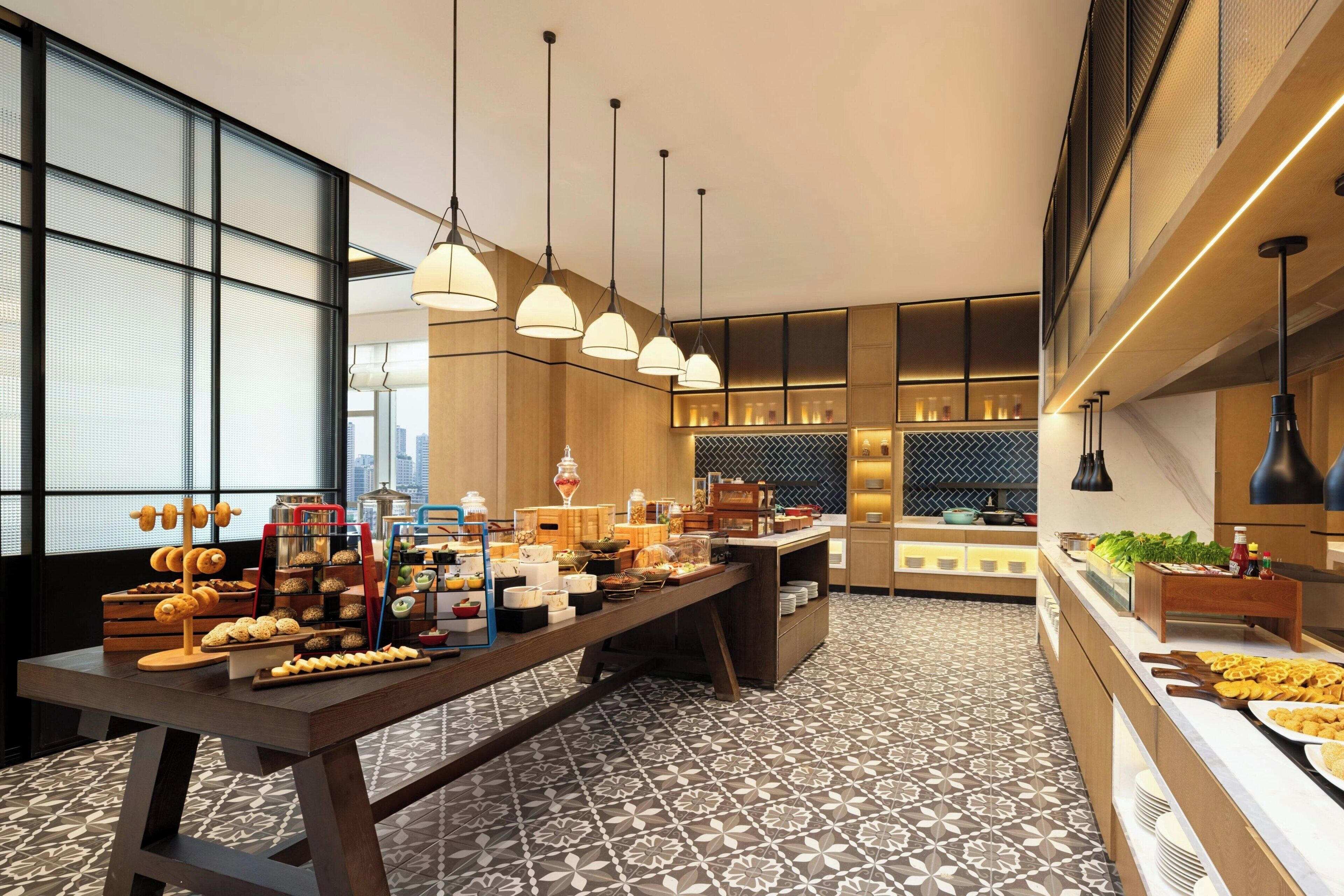 A modern breakfast buffet with a variety of food items and a patterned floor.