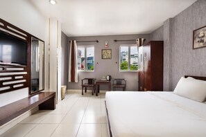 A hotel room with a bed, a desk, a television, and a view of the outside. - Sen Saigon Hotel (Ho Chi Minh City)