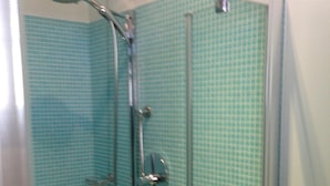 A glass-enclosed shower with a handheld showerhead and a handheld shower attachment. - Joia Luxury Hotel Luxury Apartments (Brusaporto)