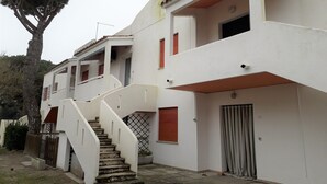 A multi-story residential building with a staircase leading to the upper floors. - Beachside Villa For a Family (Rosolina Mare RO)