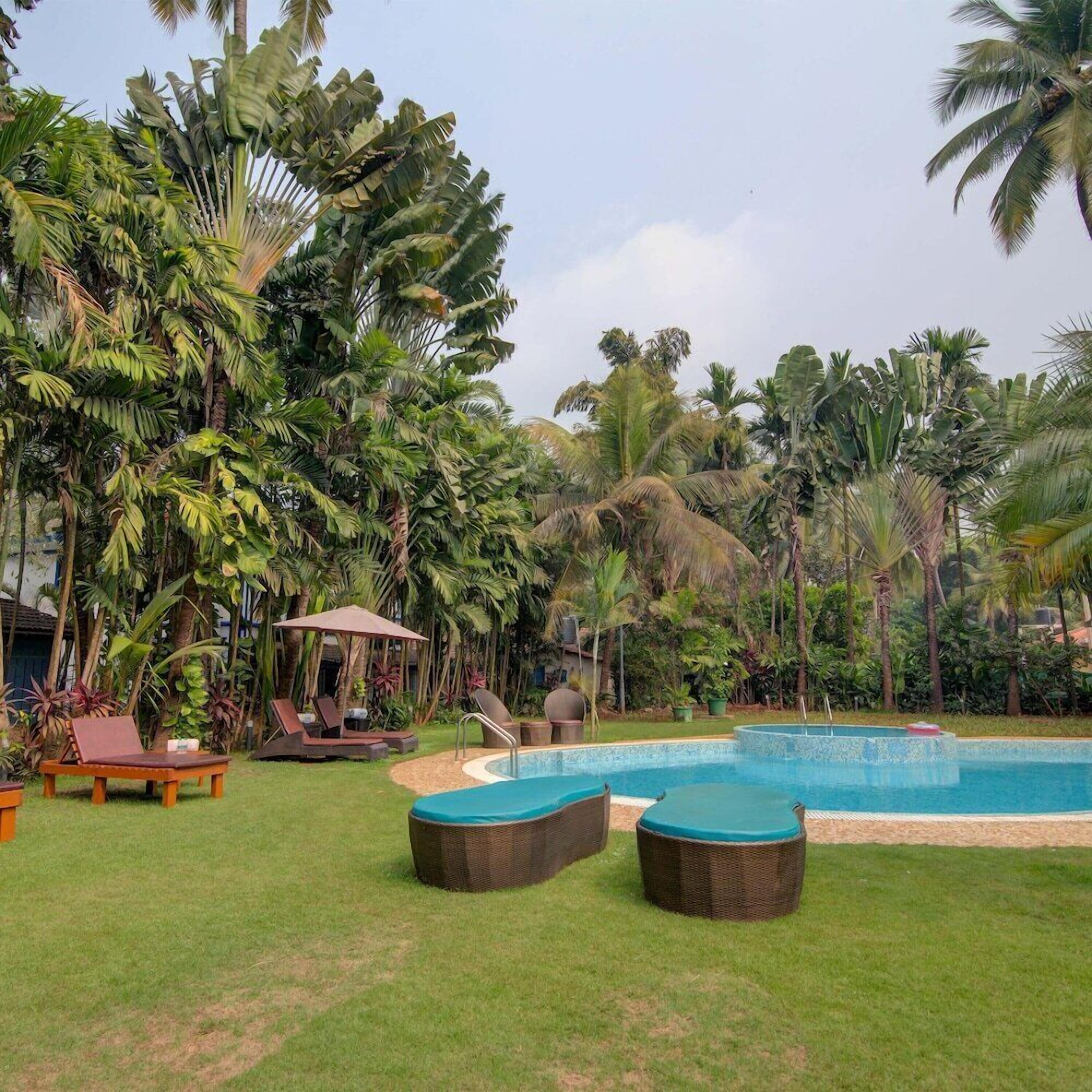 A pool area with lounge chairs and a small pool.