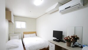A hotel room with two single beds, a desk with a computer, a mirror, and a window. - K Pop Residence I (Seoul)