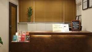 A reception desk with a sign indicating reception hours and a non-smoking notice. - K Pop Residence I (Seoul)