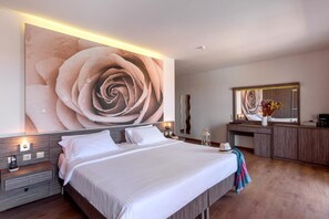 A modern bedroom with a large bed, bedside tables, a dresser, and a mirror. - Katrin Suites (Hersonissos)