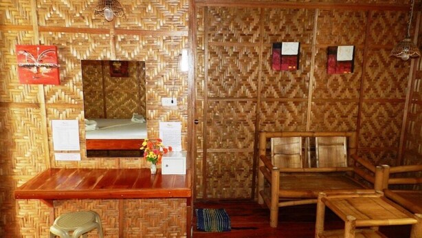 A room with a wooden desk, a mirror, a small stool, and two wooden chairs. - Panglao Chocolate Hills Resort (Panglao)