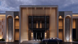 Un bâtiment moderne avec une enseigne indiquant « Restaurant » au-dessus de l’entrée.