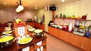 A buffet setup with various food items and utensils, including rice, porridge, and a variety of fruits. - Nice Hotel (Kaohsiung)