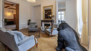 A spacious living room with a fireplace, a chandelier, and a large mirror. - Guest Room 4 with Shared Terrace, Wi-Fi and Air Conditioning (Joze)