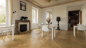 A spacious room with a fireplace, white furniture, and a bookshelf. - Guest Room 4 with Shared Terrace, Wi-Fi and Air Conditioning (Joze)