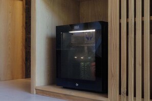A GEA refrigerator in a wooden cabinet with a GE logo on the top. - Suara Air Luxury Villa Ubud (Ubud)
